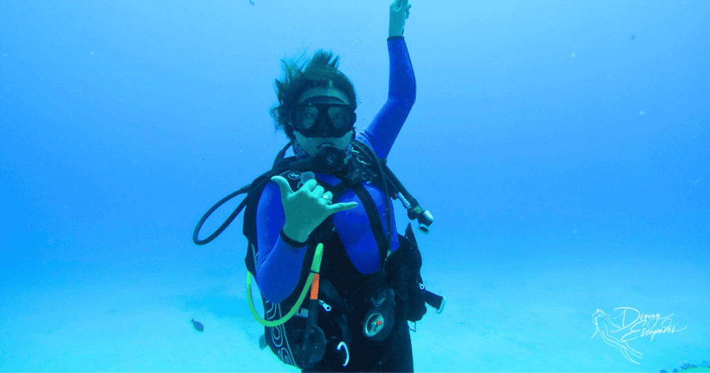 scuba diving in Oahu and buddy sporting the Shaka