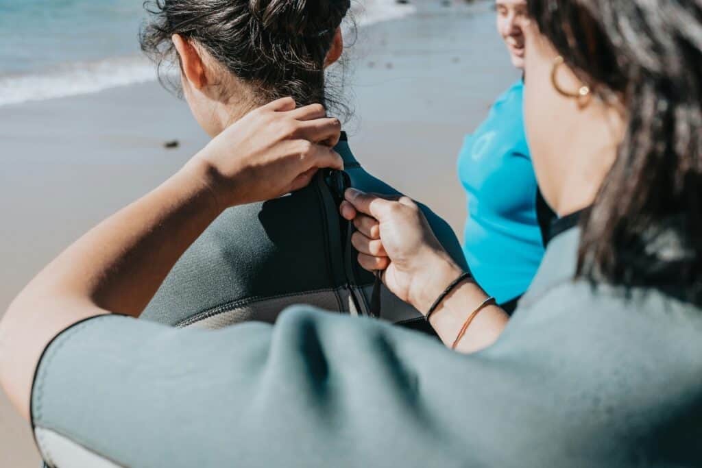 women wearing wetsuits
