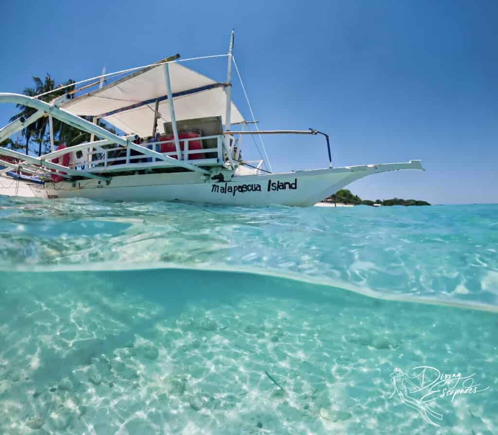 Malapascua Island outrigger boat, half underwater, half above