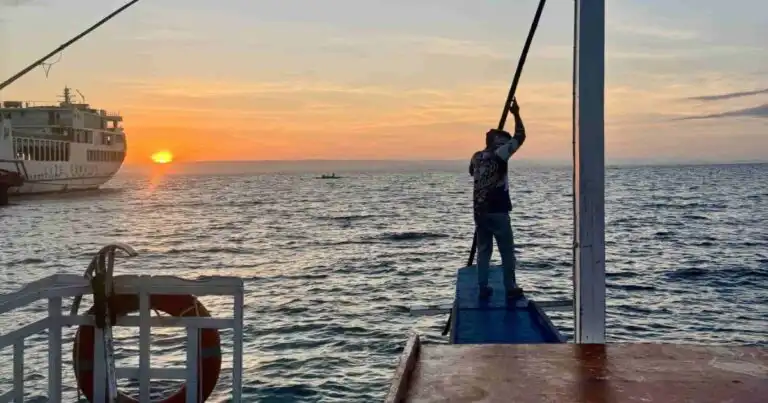 Private boat leaving Maya Port for Malapascua at sunrise.