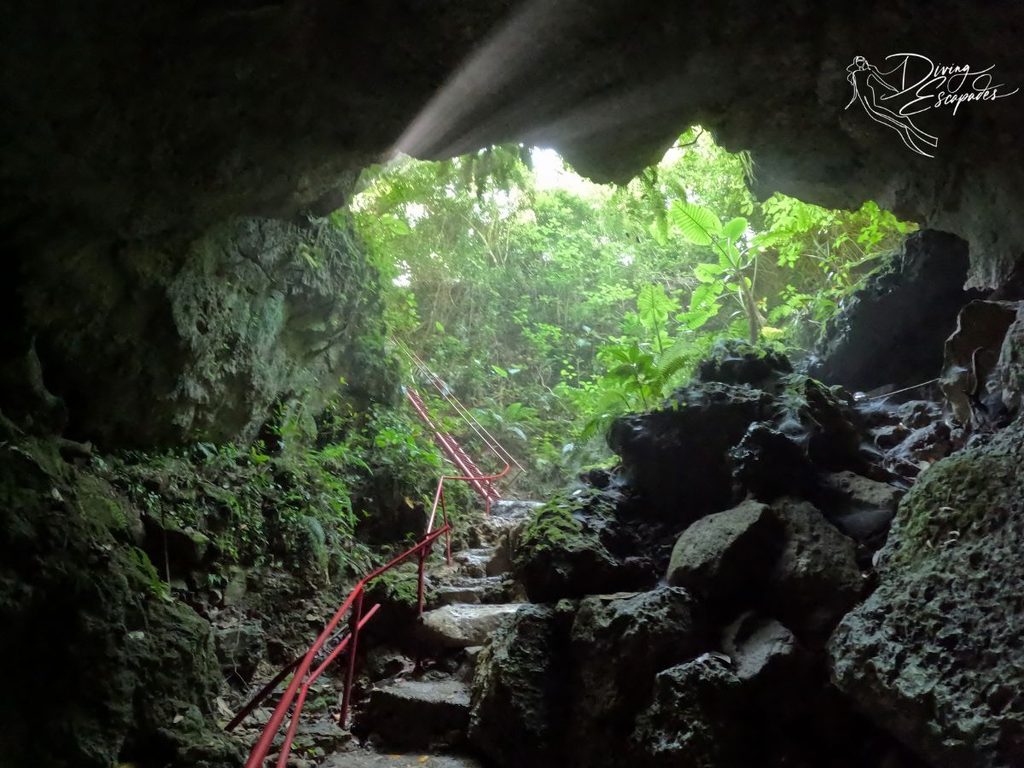 Sambulawan Cave entrance with red railings on the stairs.