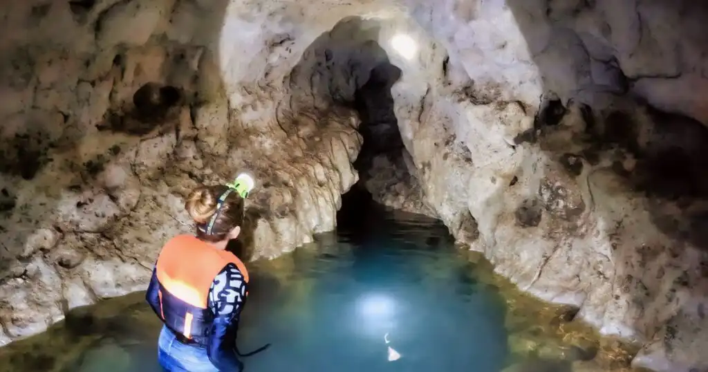 Me inside Sambulawan Cave in Siquijor with turquoise waters.
